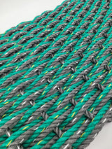 image shows a gray and green double weave rope mat