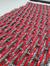image shows a gray and red double weave rope mat