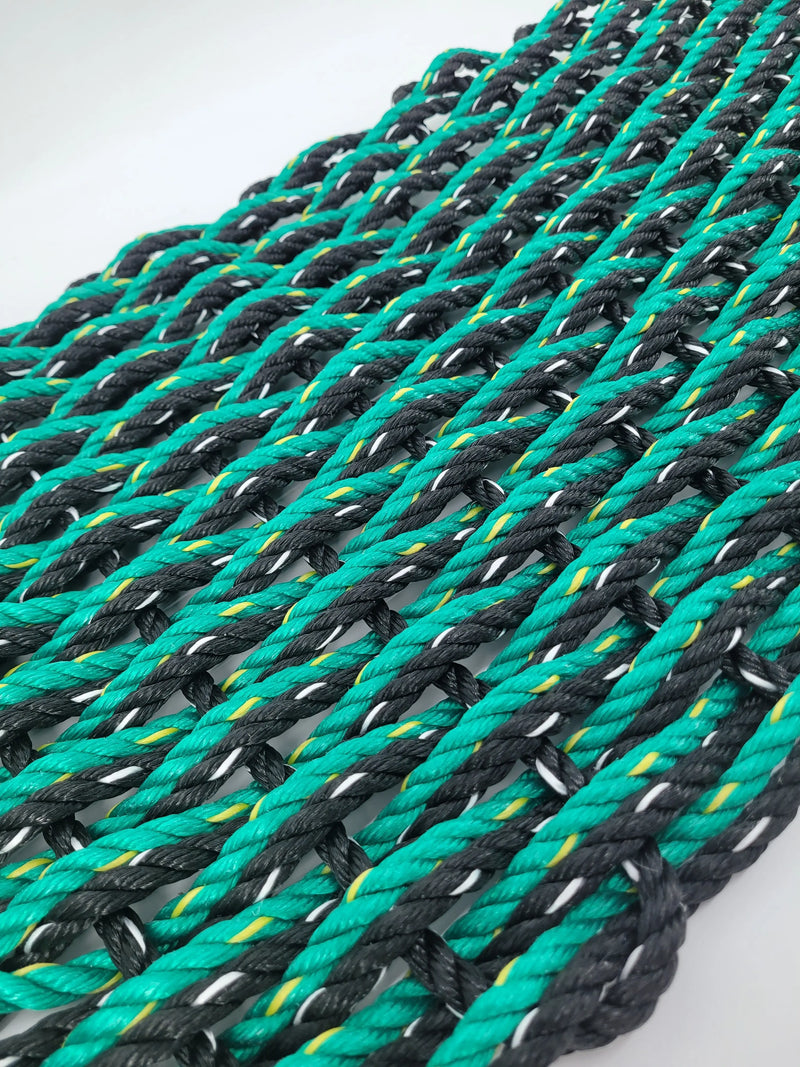 image shows a black and green double weave rope mat