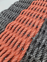 Gray and coral orange lobster rope mat
