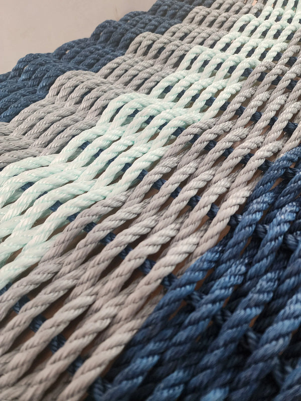 5 Stripe Lobster Rope Mat in the color pattern navy Blue, light gray seafoam light gray and navy blue