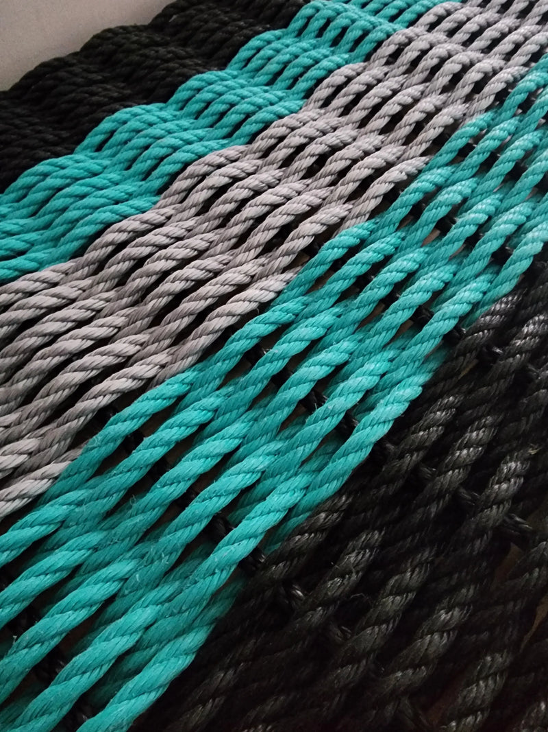 Image shows a 5 Stripe rope mat in the colors Black, Teal, Gray, Teal Black