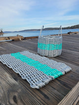 image shows a gray and teal matching lobster rope mat and basket