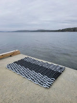 image shows a black and gray double weave lobster rope mat, black stripe in the middle